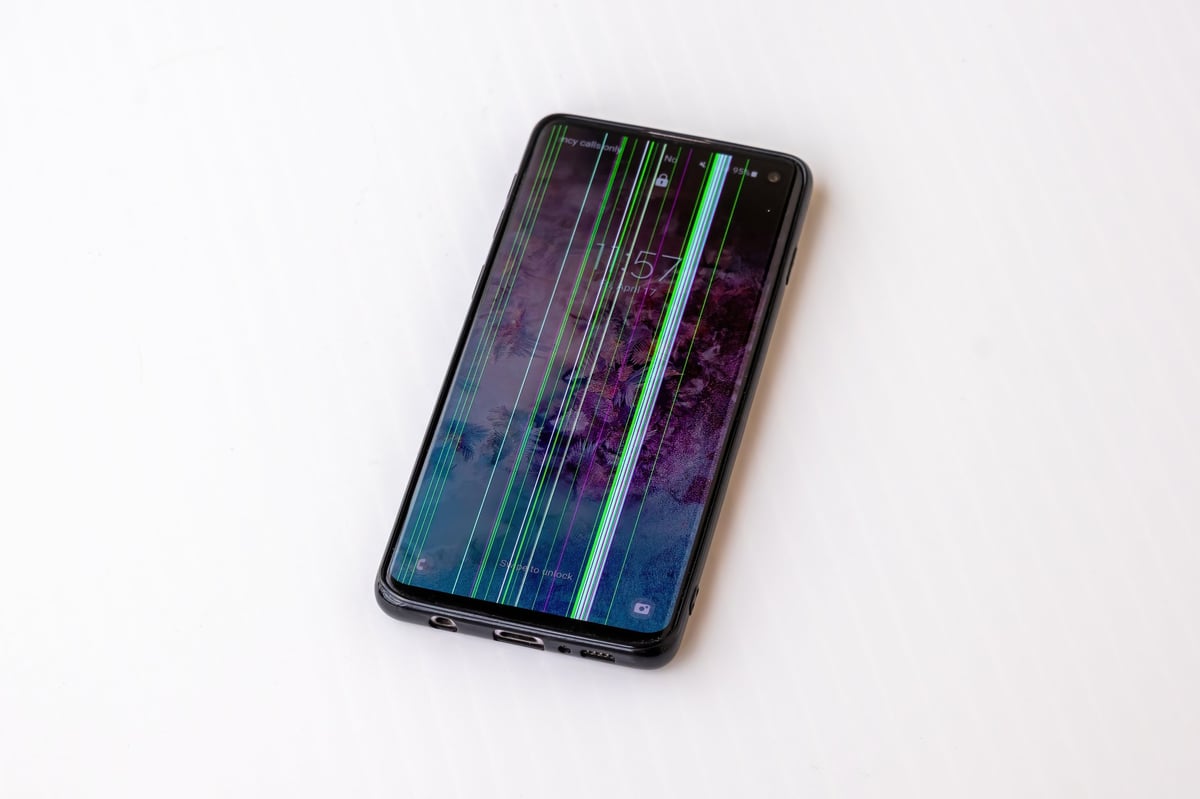 A modern smartphone held against a dark studio background